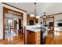 Kitchen island with cooktop and a view into adjacent living areas at 2292 Acworth Due West Nw Rd, Acworth, GA 30101