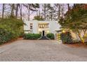 Modern white house with a large garage and stone steps at dusk at 780 Crest Valley Dr, Atlanta, GA 30327