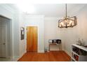 Bright dining area with hardwood floors and modern chandelier at 799 Hammond Dr # 116, Atlanta, GA 30328