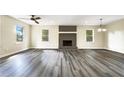 Bright living room with hardwood floors and a brick fireplace at 3811 Reynolds Rd, Douglasville, GA 30135