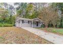 Front view of the house with a long driveway at 7047 Carolyn Cir, Lithia Springs, GA 30122
