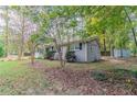 Side view of the house showcasing the backyard and shed at 7047 Carolyn Cir, Lithia Springs, GA 30122