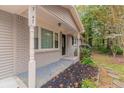 Front porch entrance with columns and landscaping at 7047 Carolyn Cir, Lithia Springs, GA 30122