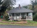 Quaint light blue bungalow with a front porch at 210 Burge St, Canton, GA 30114