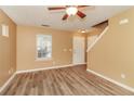 Living room with wood-look floors, ceiling fan and view of entryway at 126 Silver Fox Trl, Dallas, GA 30157