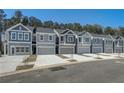 Row of gray townhomes with attached garages and driveways at 5178 Longview Run, Decatur, GA 30035