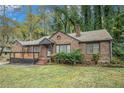 Brick ranch house with a deck and well-maintained lawn at 970 Tuckawanna Dr, Atlanta, GA 30311