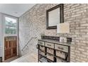 Inviting entryway with exposed brick wall and storage bench at 1331 Peachtree Ne Vw, Atlanta, GA 30319