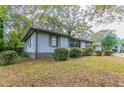 Side view of the house showcasing the well-maintained lawn at 2191 Miriam Ln, Decatur, GA 30032