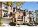 Three-story brick townhouses with balconies and attached garages at 226 Mclaren Gates Dr, Marietta, GA 30060