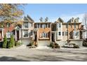 Row of townhouses with attached garages and neatly landscaped yards at 226 Mclaren Gates Dr, Marietta, GA 30060