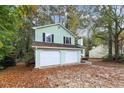 Light green house with a three-car garage at 4027 Evelyn Dr, Powder Springs, GA 30127
