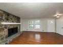 Spacious living room with hardwood floors and stone fireplace at 4027 Evelyn Dr, Powder Springs, GA 30127