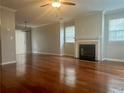 Spacious living room with hardwood floors, fireplace, and ceiling fan at 2610 Park Ave, Austell, GA 30106