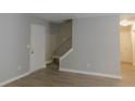 Living room with grey walls, wood-look flooring, and interior door at 99 Libby Ln, Jonesboro, GA 30238