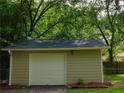 Detached single car garage with white door and light taupe siding at 99 Libby Ln, Jonesboro, GA 30238