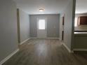 Dining area with grey walls, wood-look flooring, and access to kitchen at 99 Libby Ln, Jonesboro, GA 30238