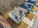 An aerial perspective showcasing a residential home with a backyard and driveway at 4430 Ambassador Way, Cumming, GA 30040