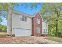 Two-story home with brick and beige vinyl siding at 5941 S Deshon Ct, Lithonia, GA 30058