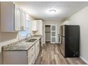 Modern kitchen with granite countertops and stainless steel appliances at 3730 Douglas Ridge Trl, Douglasville, GA 30135