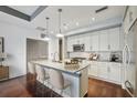 Modern white kitchen with island and hardwood floors at 1100 Howell Mill Nw Rd # 408, Atlanta, GA 30318