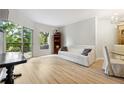 Light-filled living room featuring wood floors and access to balcony at 1 Biscayne Nw Dr # 107, Atlanta, GA 30309