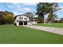 White brick house with a two-car garage and a large front yard at 2611 Kings Cir, Lawrenceville, GA 30044