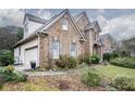 Brick and siding house with landscaped yard at 2194 Ne Indian Shoals Dr, Loganville, GA 30052