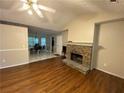 Bright living room with hardwood floors and a stone fireplace at 95 Brandon Dr, Covington, GA 30016