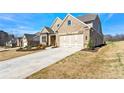 Brick home with a three-car garage and landscaping at 2640 Joseph Dr, Cumming, GA 30028