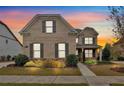 Brick house with gray shutters and walkway at 11075 Ellsworth Cv, Suwanee, GA 30024