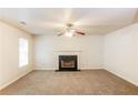 Spacious living room featuring a fireplace and carpeted floors at 6257 Selborn Sw Dr, Atlanta, GA 30331