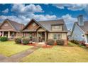 Charming craftsman style home with a covered porch and landscaping at 132 Tan Yard Rd, Social Circle, GA 30025