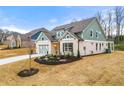 Two-story craftsman style home with light green and brick exterior at 2645 Joseph Dr, Cumming, GA 30028