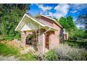 Brick home with covered porch and mature trees at 250 Big Oak Rd, Whitesburg, GA 30185