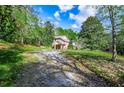 Brick house with long gravel driveway and grassy yard at 250 Big Oak Rd, Whitesburg, GA 30185