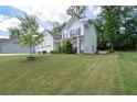 Two story home with white siding, three car garage and manicured lawn at 197 Stafford Ln, Villa Rica, GA 30180