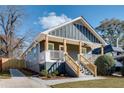 Renovated craftsman bungalow, gray siding, front porch, and steps at 1078 Hobson Sw St, Atlanta, GA 30310