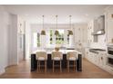 Modern kitchen with white cabinets, island, and pendant lighting at 625 Mayfair Ct, Alpharetta, GA 30009
