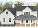 White farmhouse with a metal roof and front porch at 64 Maple St, Roswell, GA 30075