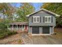 Gray two-story house with a two-car garage and stone walkway at 1010 Martin Ridge Rd, Roswell, GA 30076