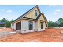 New construction home exterior with a two-car garage and partially finished landscaping at 3337 Horsley Mill Rd, Carrollton, GA 30116