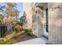 Landscaped front yard with mature trees and modern entrance at 2194 Bristol Cove # 13, Chamblee, GA 30341