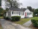 White house with red door and black shutters at 6848 Church St, Lithonia, GA 30058