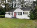 White house with red door and black shutters at 6848 Church St, Lithonia, GA 30058