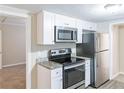 Modern kitchen with stainless steel appliances and white cabinets at 3575 Bright Star Rd, Douglasville, GA 30135