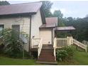 House exterior with wooden siding, steps, and a deck at 2950 Miller Bottom Rd, Conyers, GA 30012