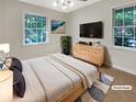 Virtually staged bedroom with a queen bed and dresser at 828 Pinevalley Dr, Forest Park, GA 30297
