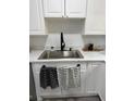 Modern kitchen with white cabinets and a stainless steel sink at 3775 Clairmont Rd, Chamblee, GA 30341