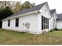 White house side with black shutters and landscaping at 290 Magnolia Walk Ln, South Fulton, GA 30349